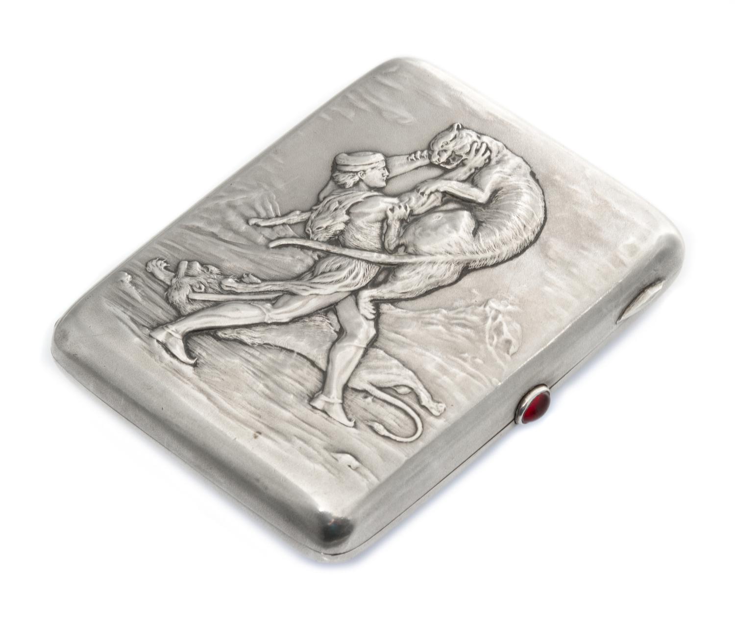 A Russian Silver Cigarette Case, Mark possibly of Fourth Jewelers Artel, Moscow, the lid worked to show a man in combat with lions, hav