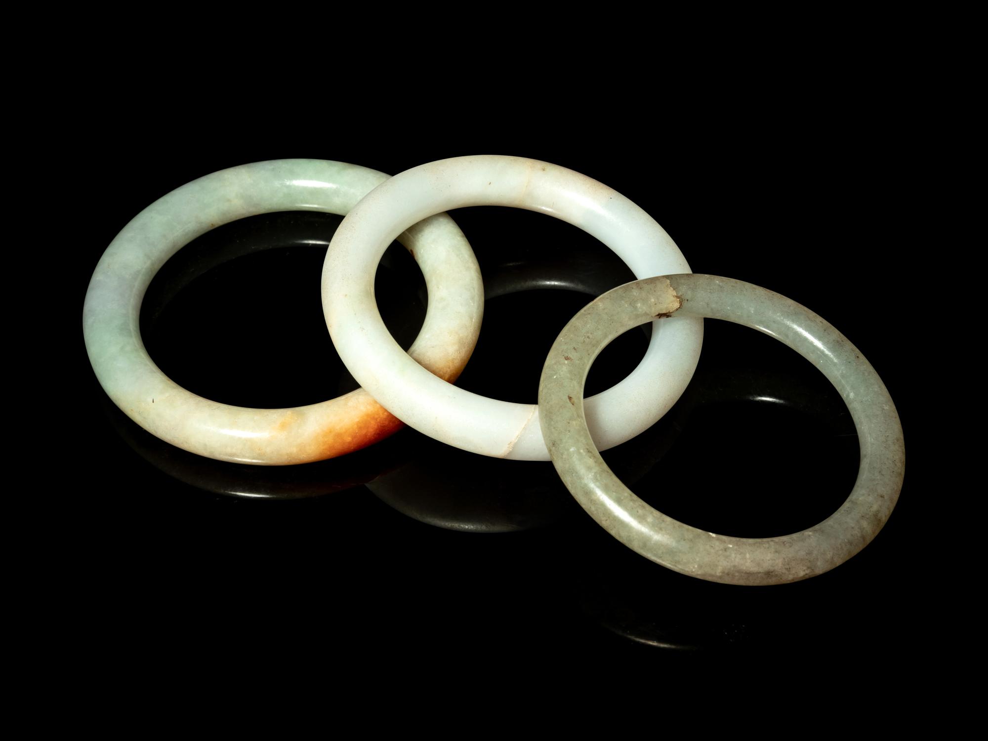 Three Chinese Jadeite and Hardstone Bangles