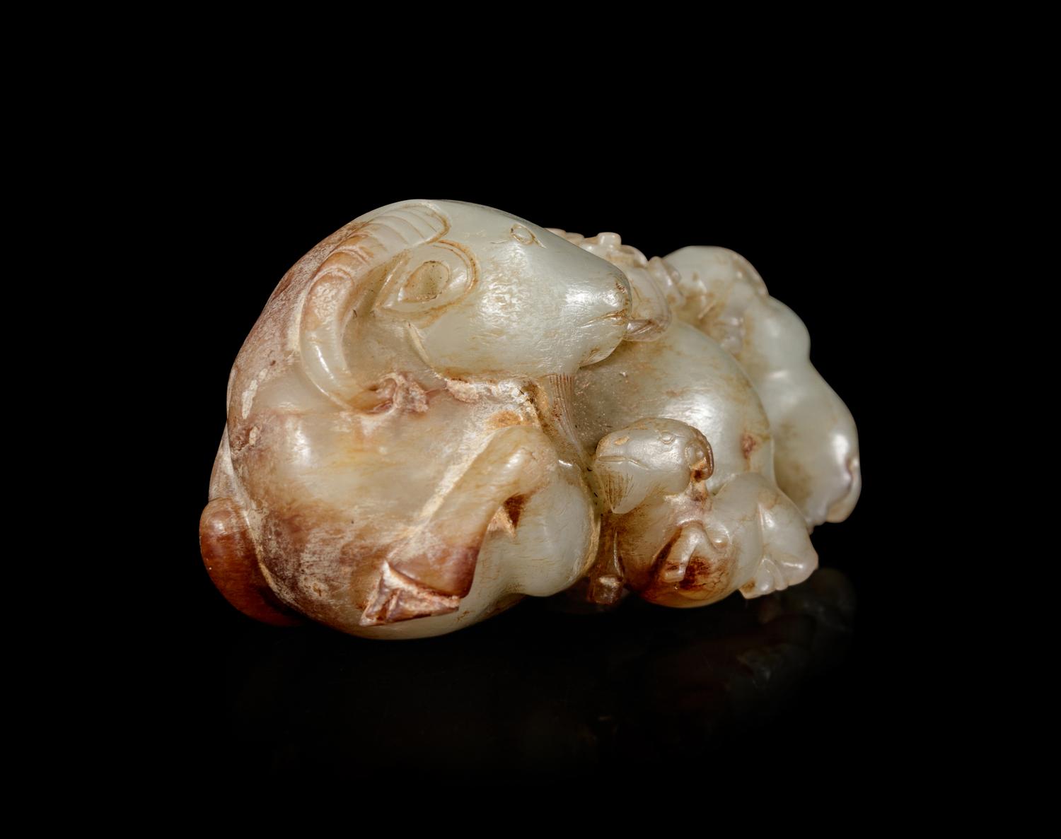 A Carved Celadon and Russet Jade 'Three Rams' Group