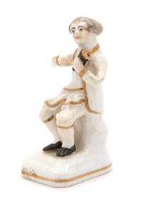 A French Porcelain Figure of a Seated Man — EARLY 19TH CENTURY