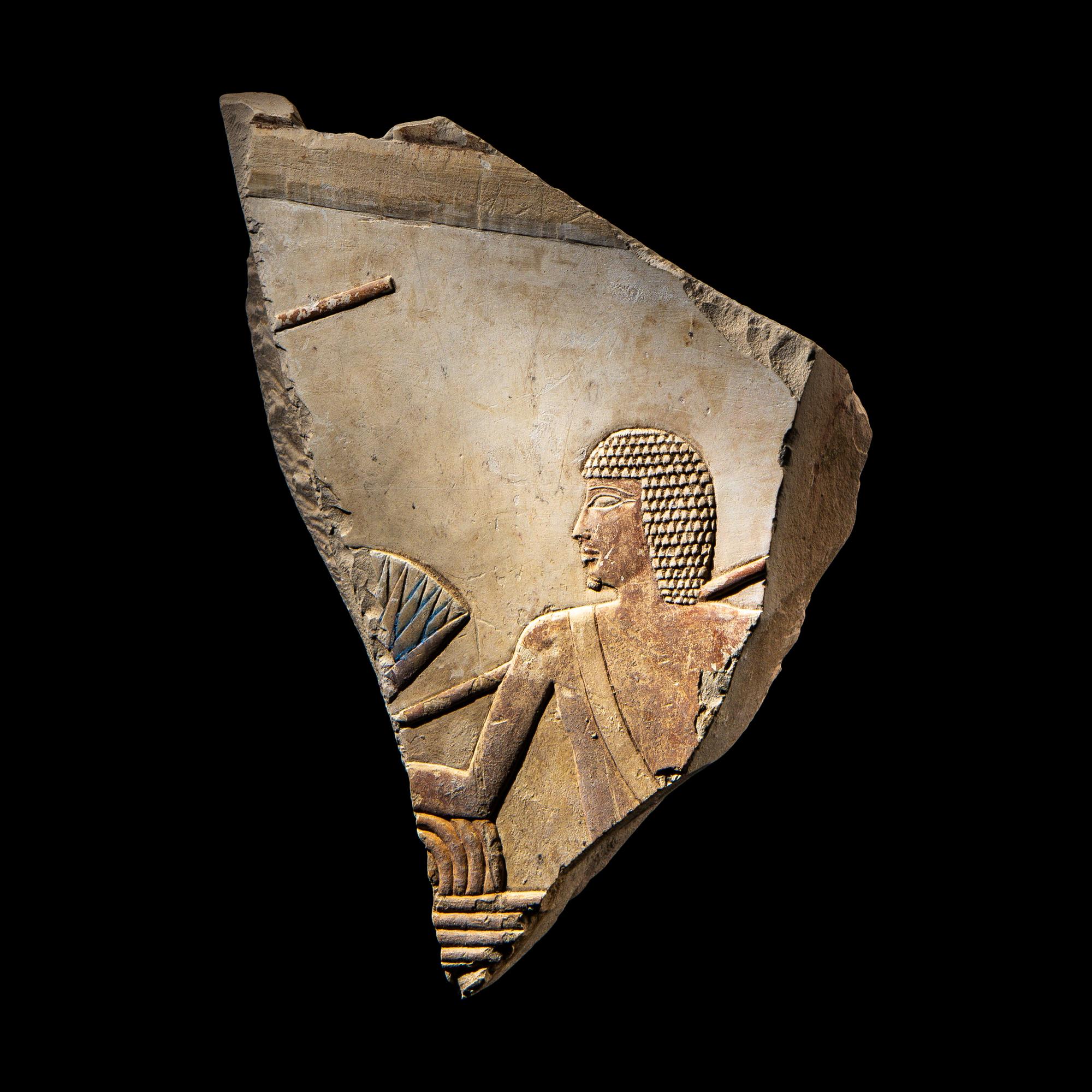 An Egyptian Painted Limestone Relief Fragment
