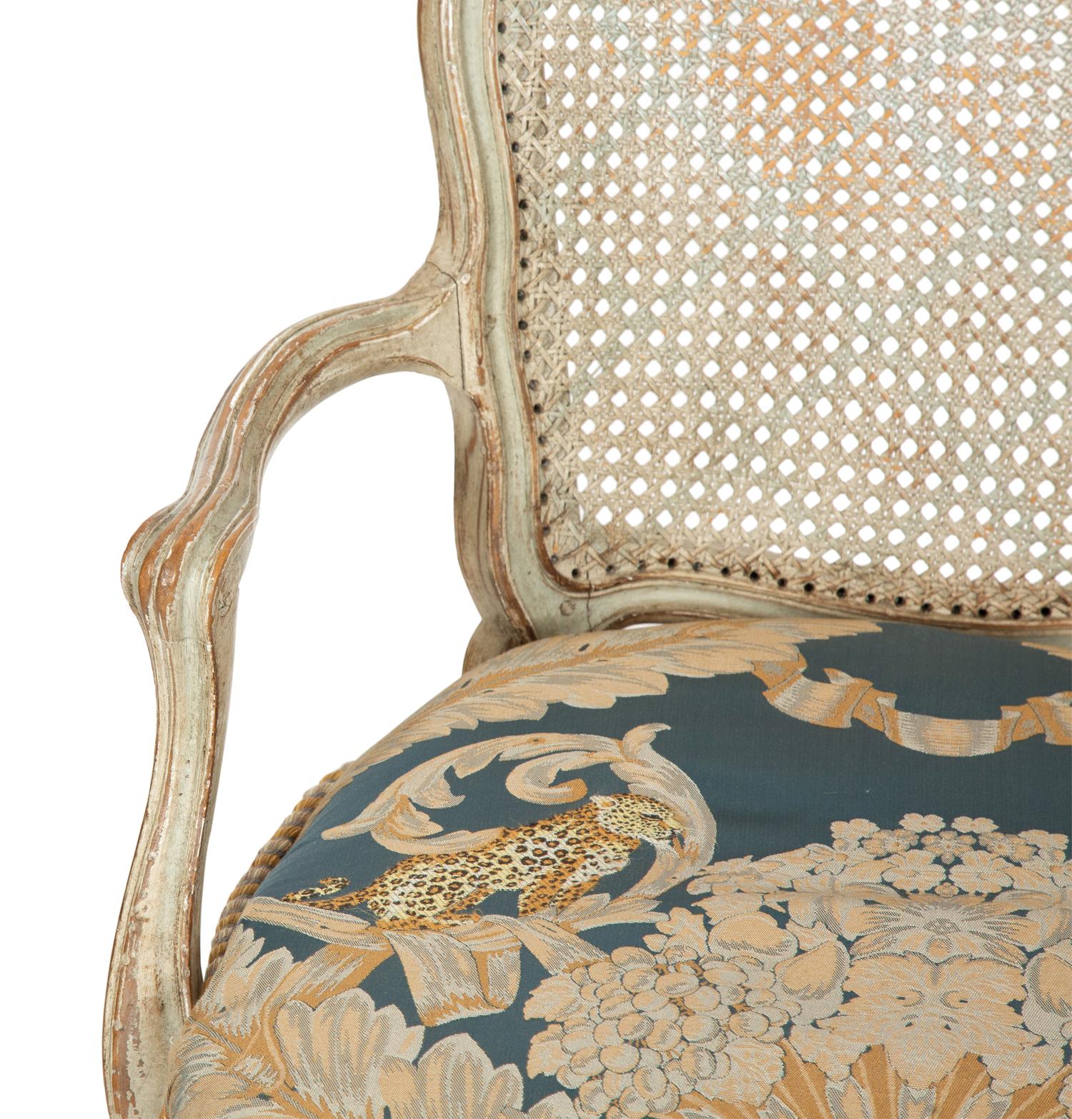 A Pair of Louis XV Blue Painted Cane-Backed Fauteuils