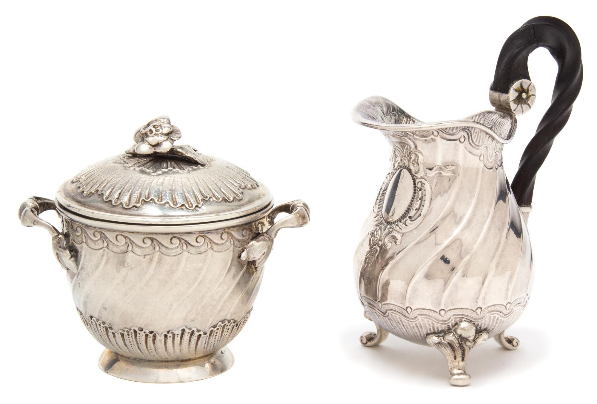 Two French Silver Articles, , comprising a covered two handled jar and a footed creamer with ebonized treen handles.