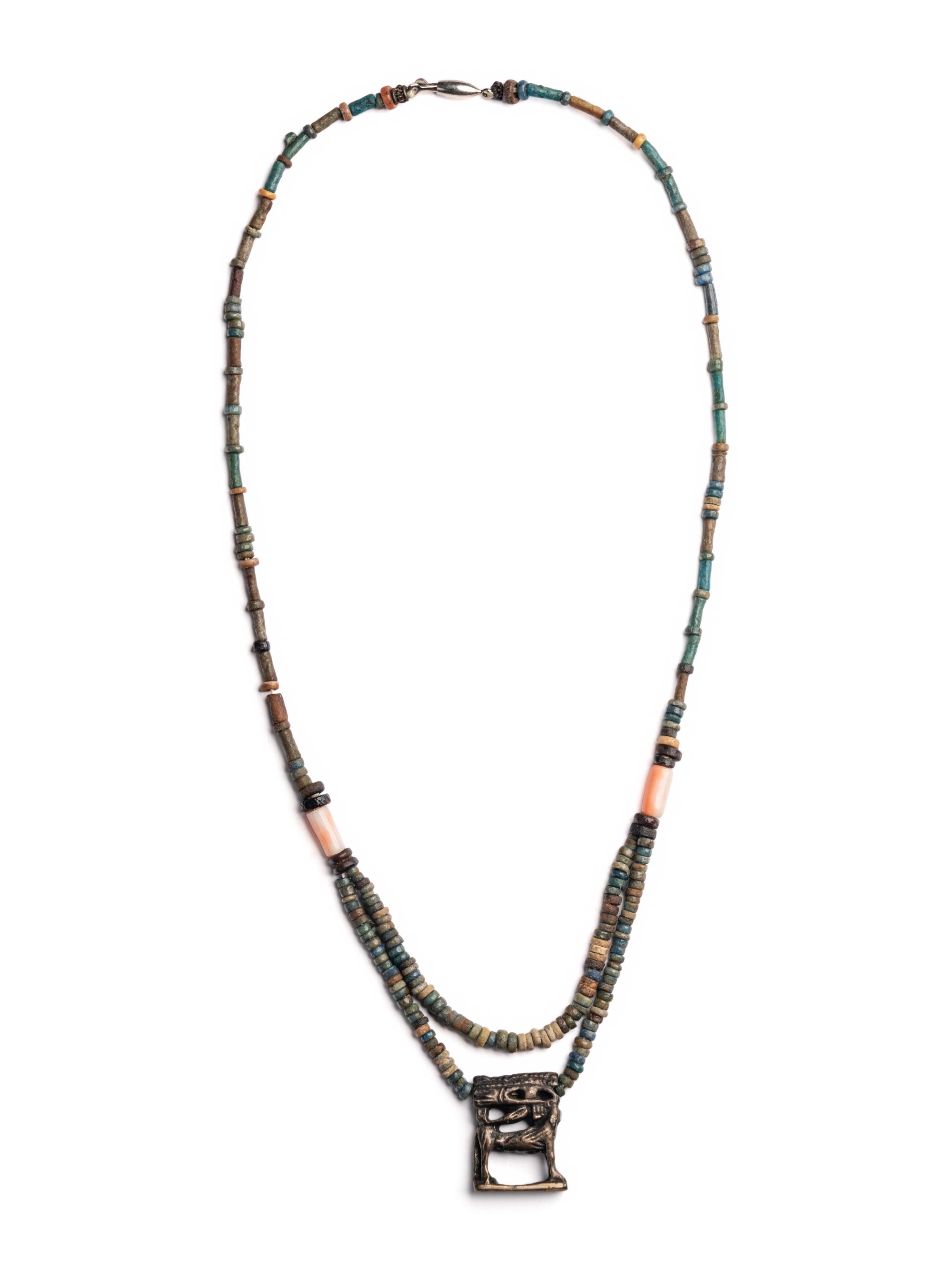 An Egyptian Bead and Faience Necklace with Silver Apis Amulet