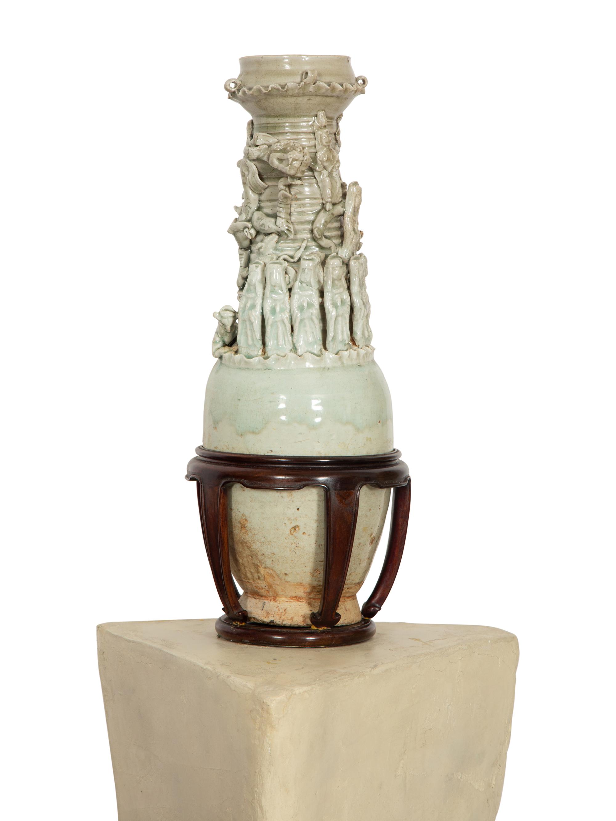 A Pair of Chinese Celadon-Glazed Funerary Urns Raised on Composition Pedestals