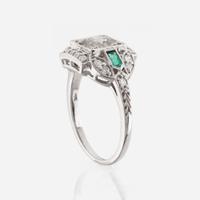 A diamond, emerald, and white gold ring