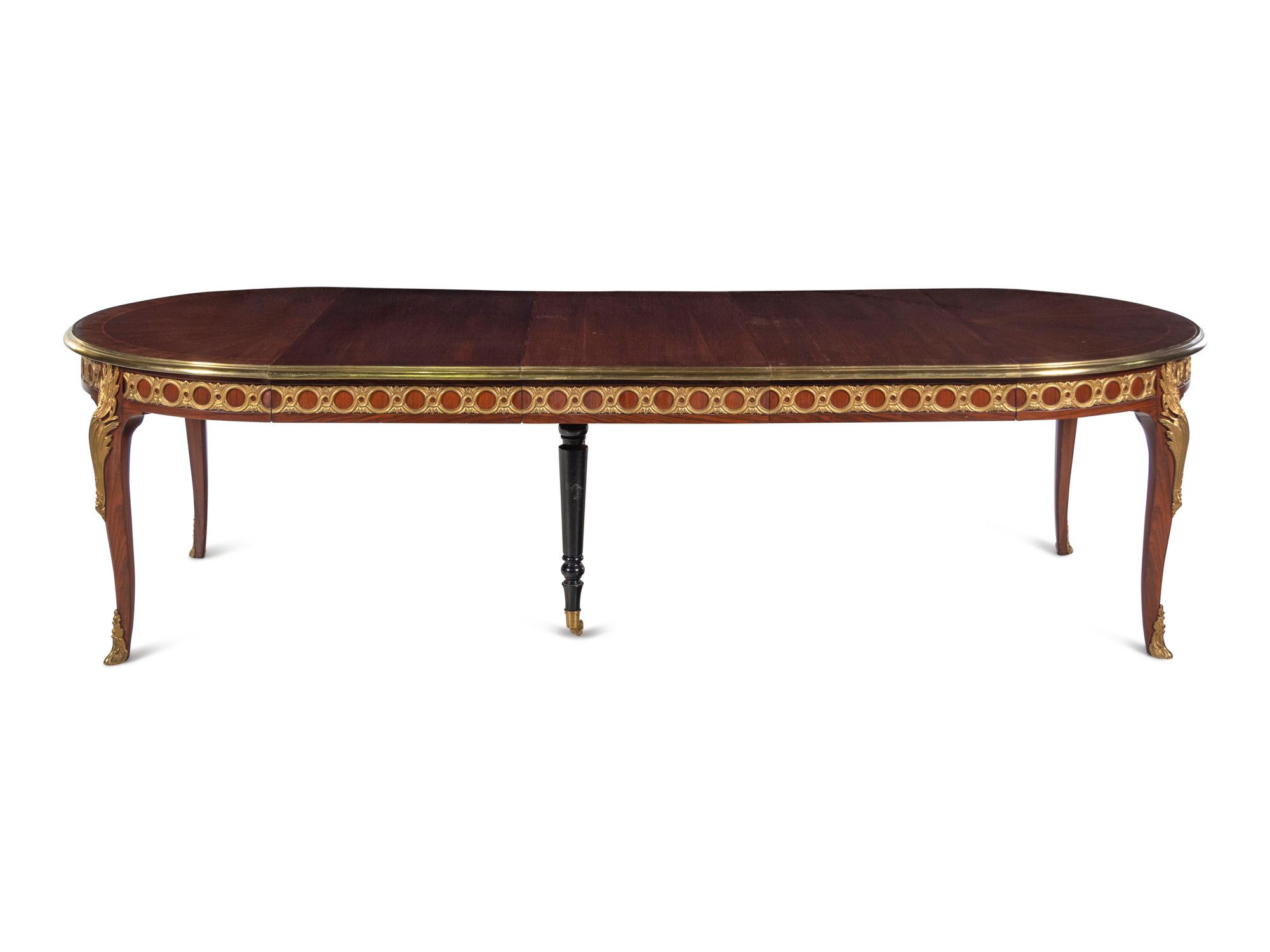 A Louis XVI Style Gilt Bronze Mounted Parquetry Dining Table