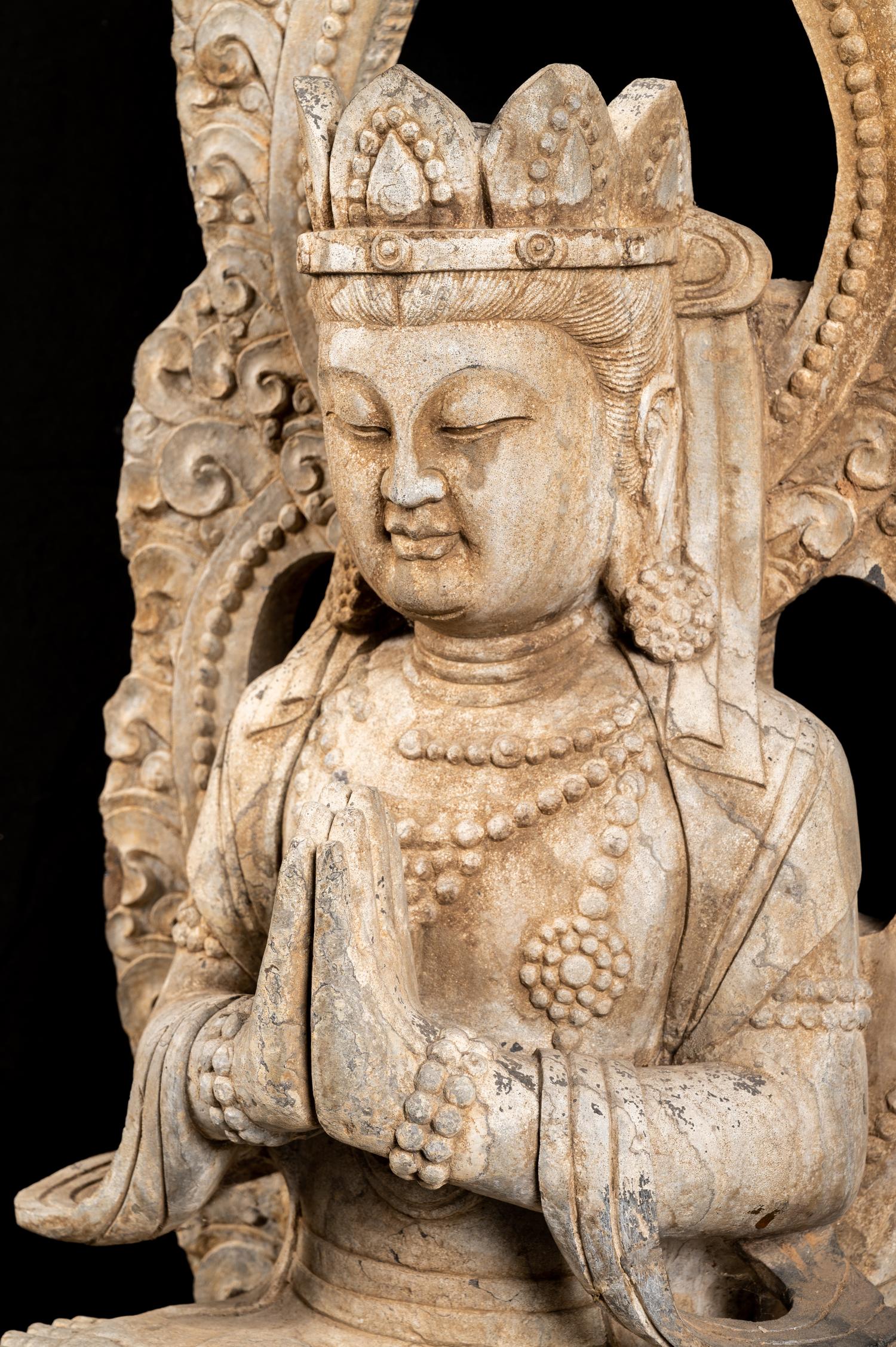 A Chinese Carved Stone Seated Guanyin Figure