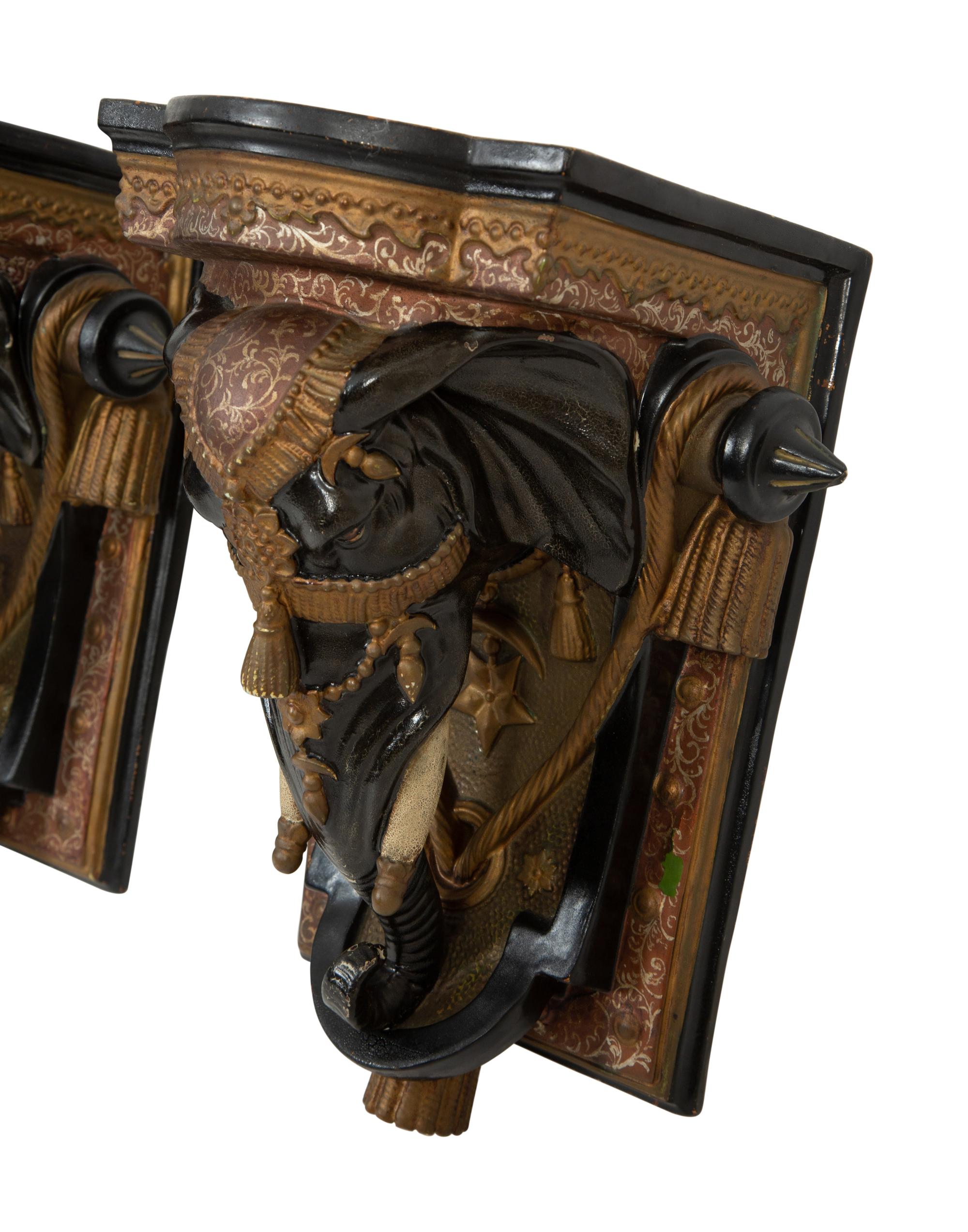 A Pair of Painted and Parcel Gilt Earthenware Elephant-Form Wall Brackets