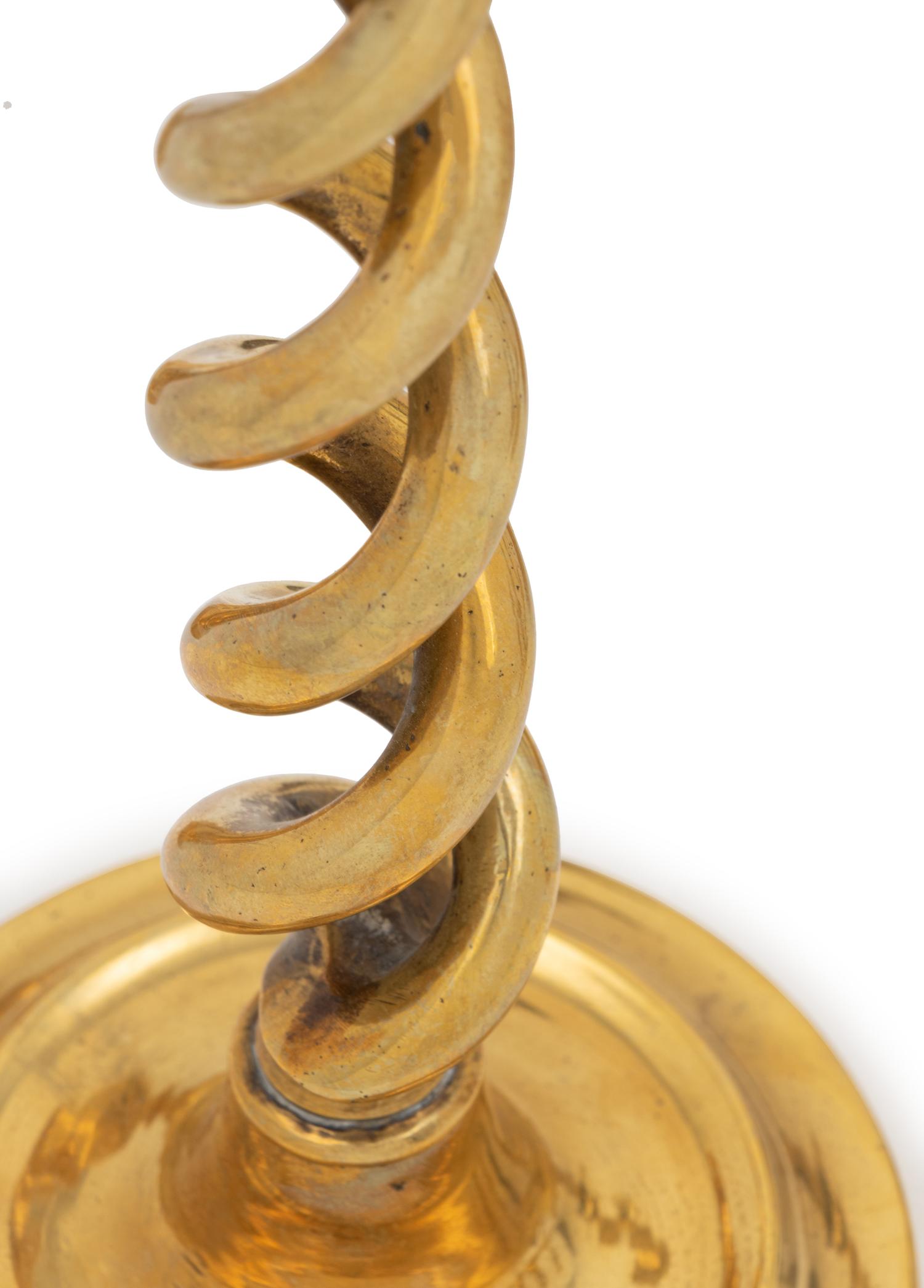 A Group of Four Pairs of English Brass Candlesticks