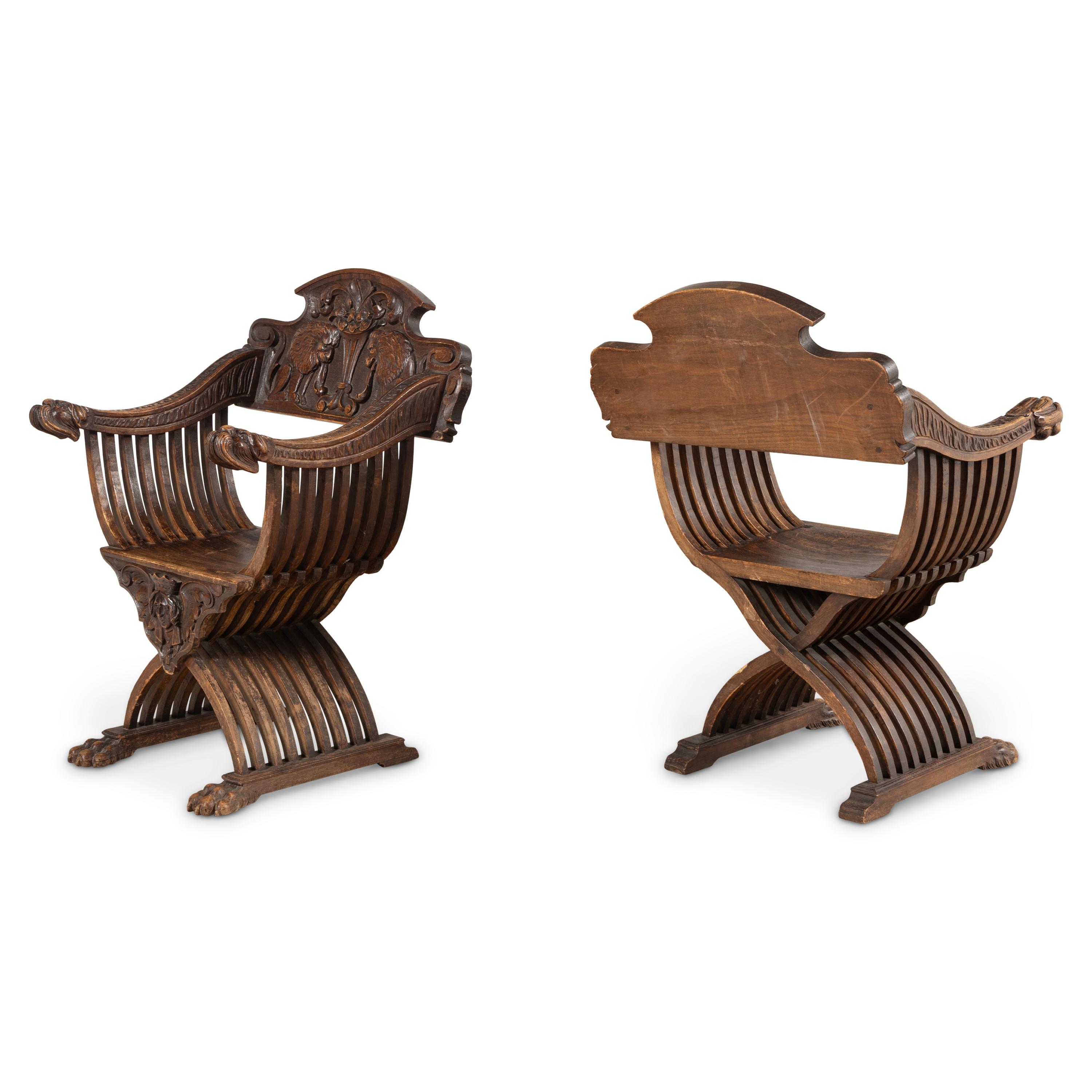 A Pair of Italian Carved Walnut Savonarola Chairs