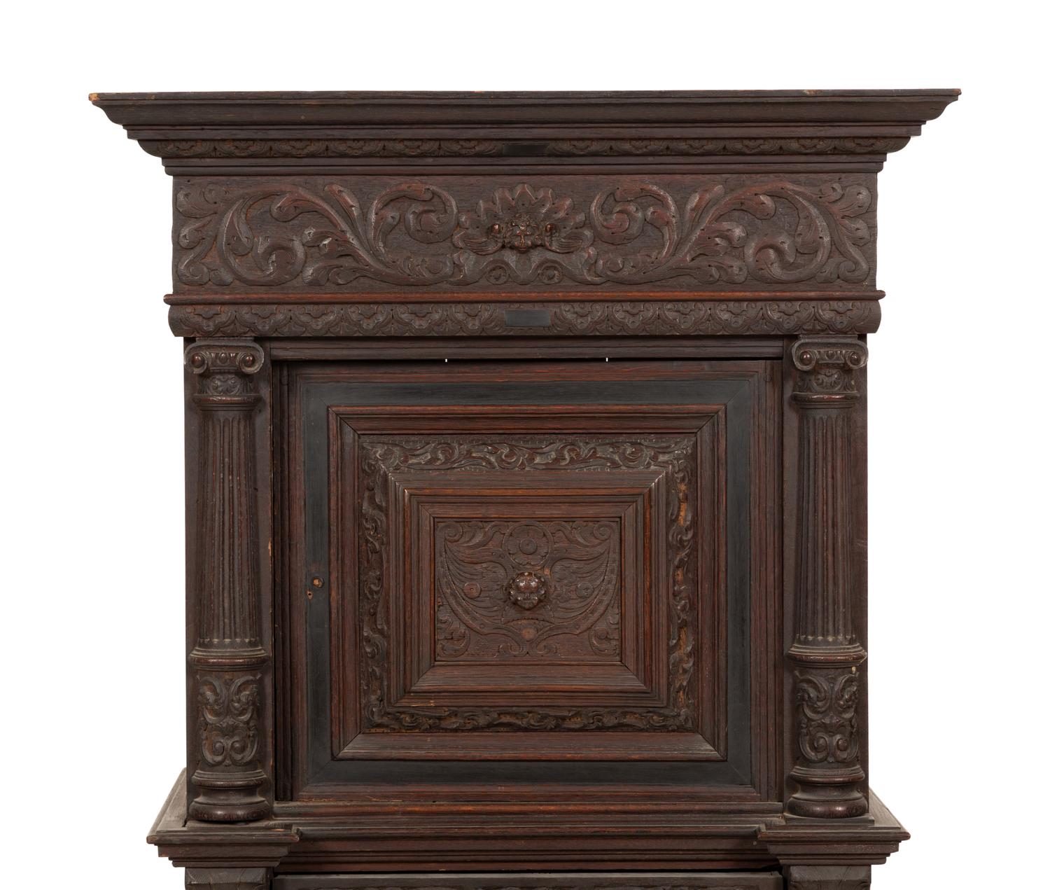 A Pair of Continental Carved Oak Cabinets on Stands