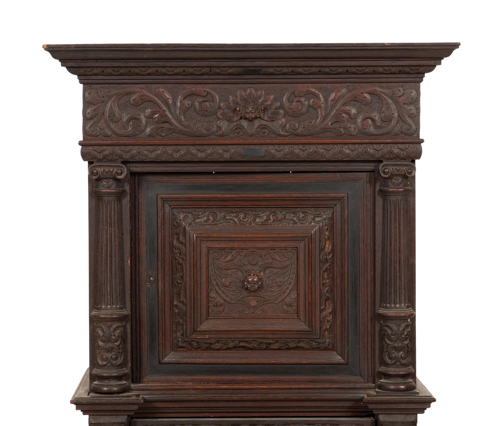 A Pair of Continental Carved Oak Cabinets on Stands