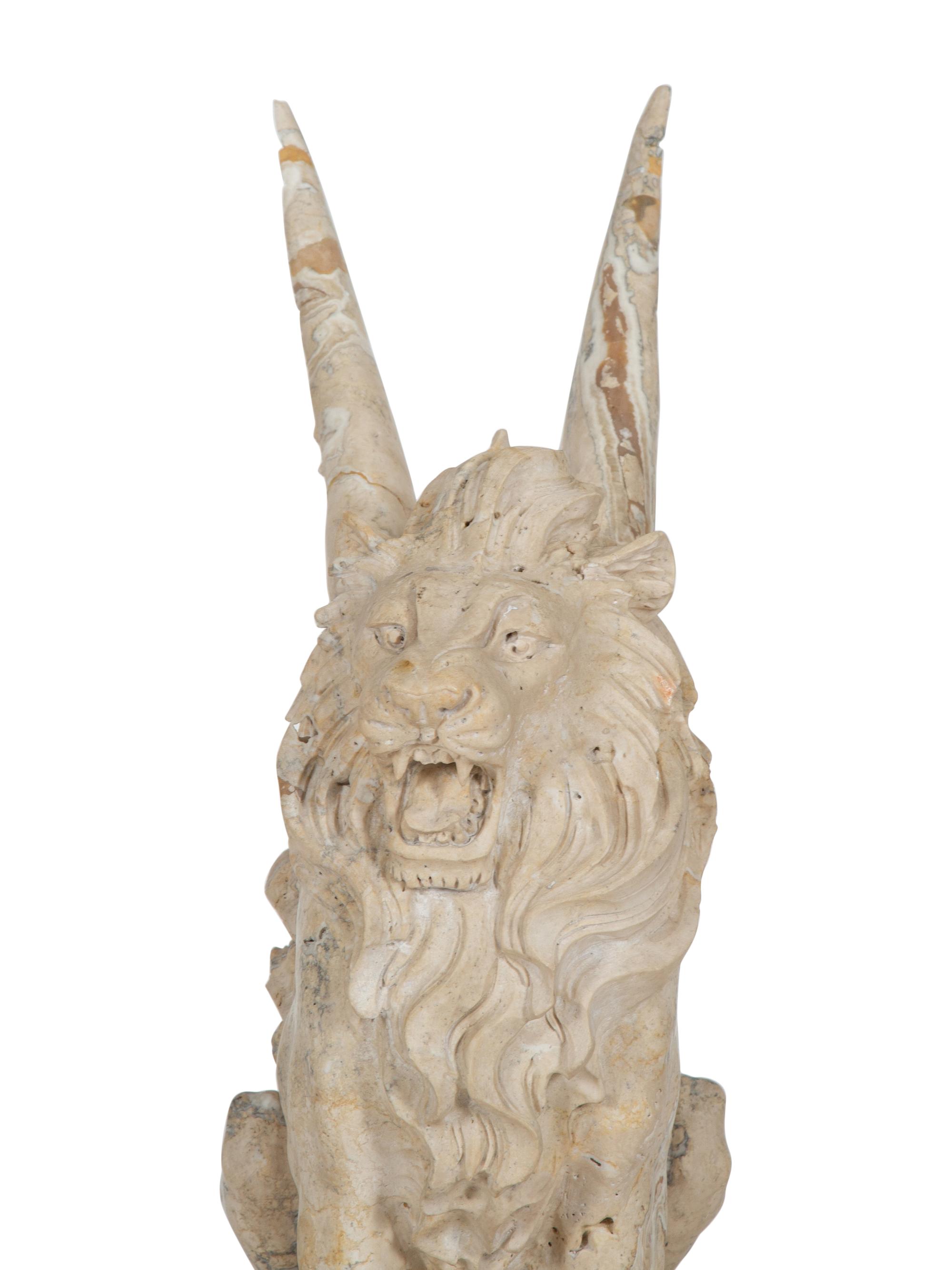 A Carved Marble Winged Seated Lion on Pedestal Base