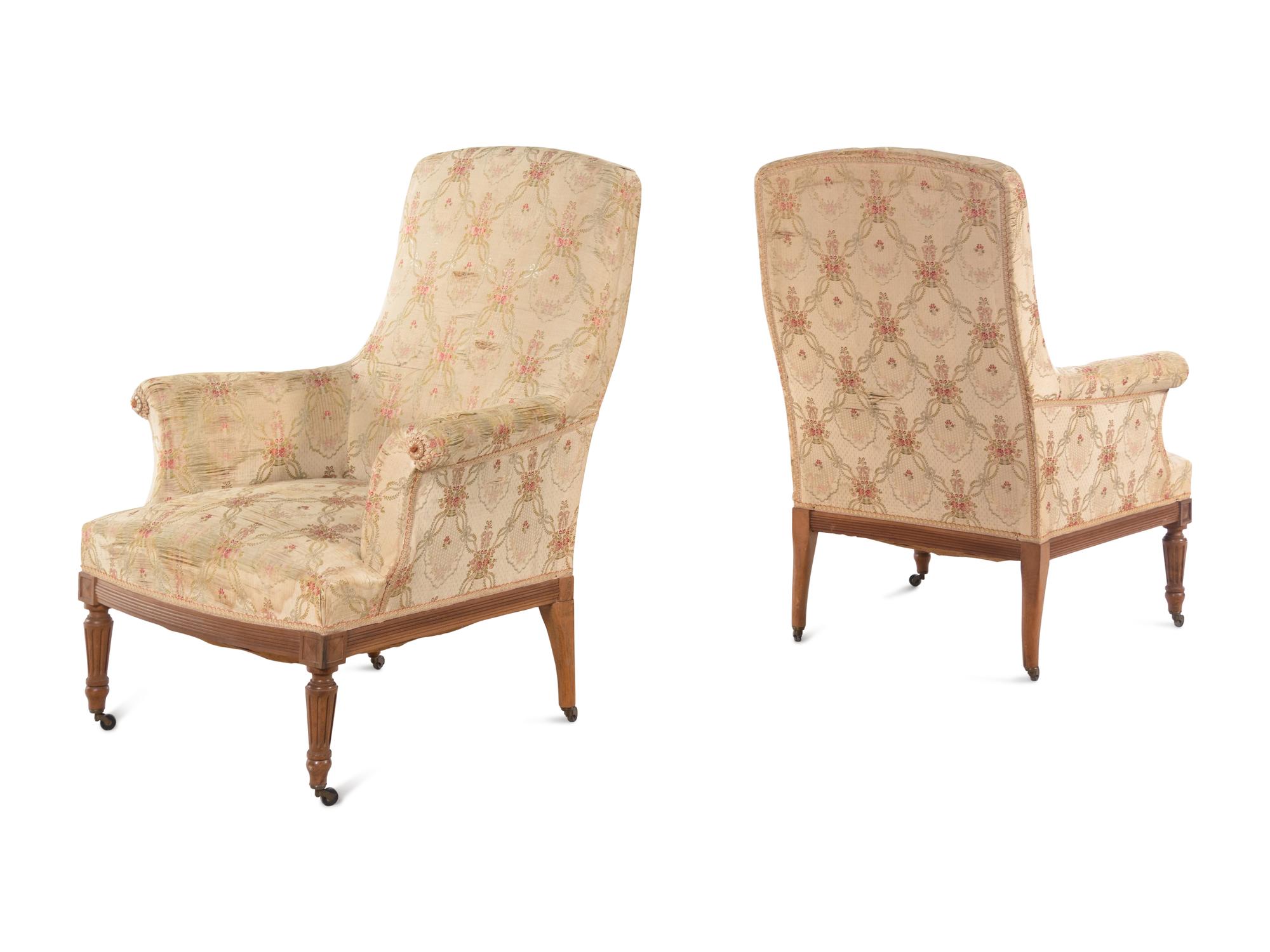 A Pair of Louis XVI Style Walnut Easy Chairs