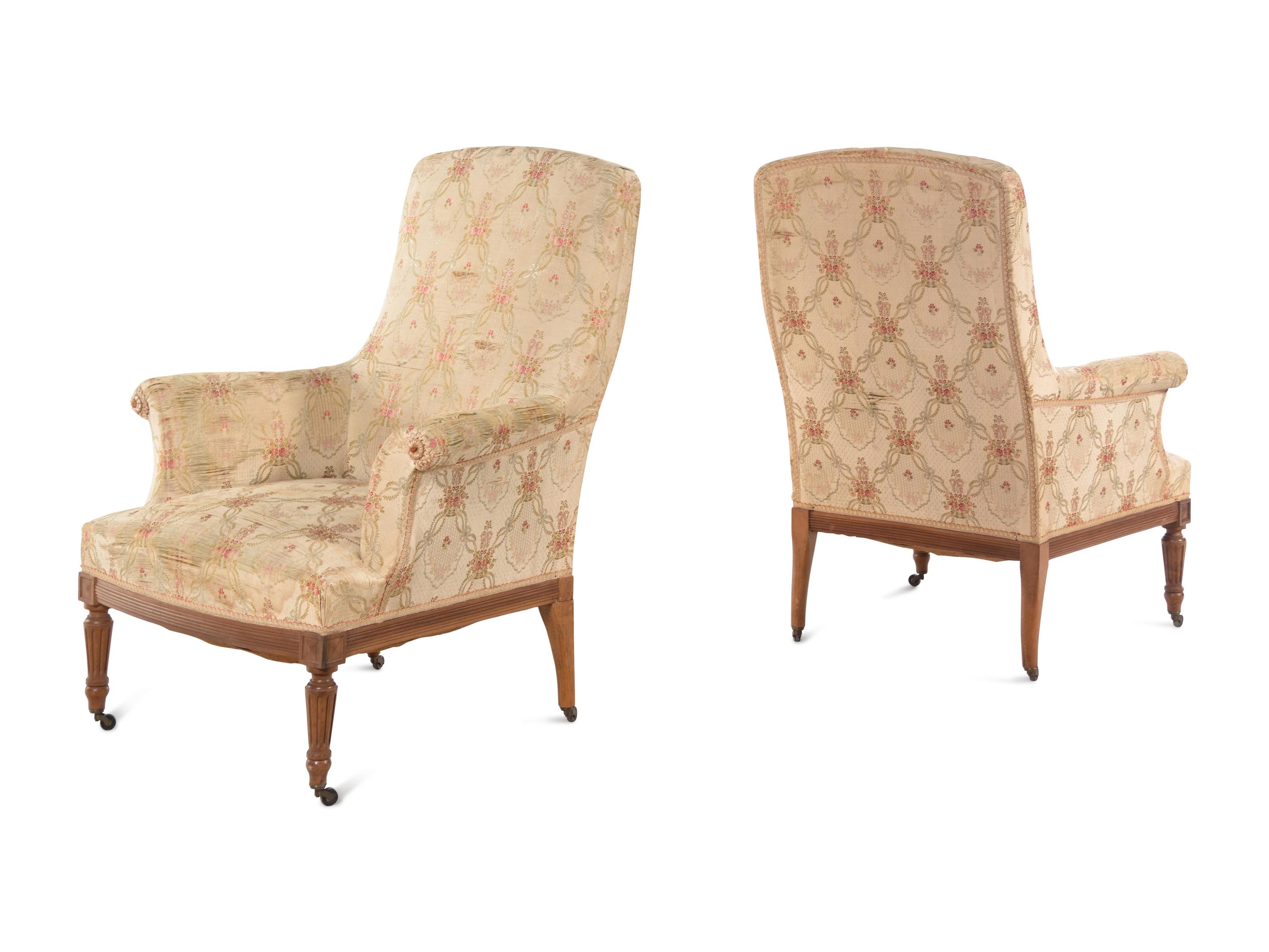A Pair of Louis XVI Style Walnut Easy Chairs