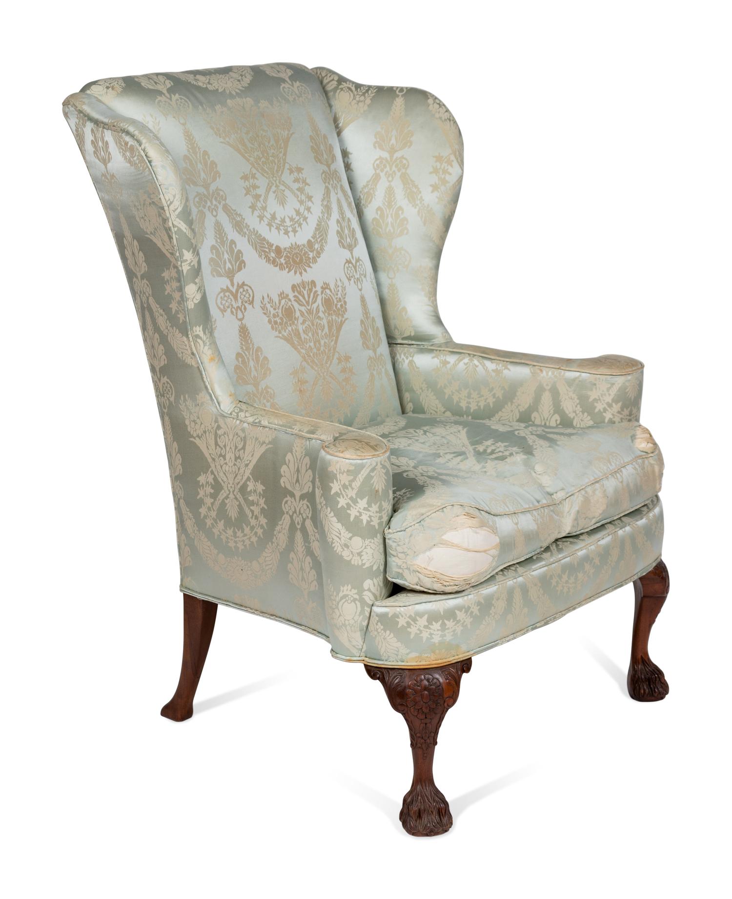 A George II Style Upholstered and Carved Mahogany Wing Armchair