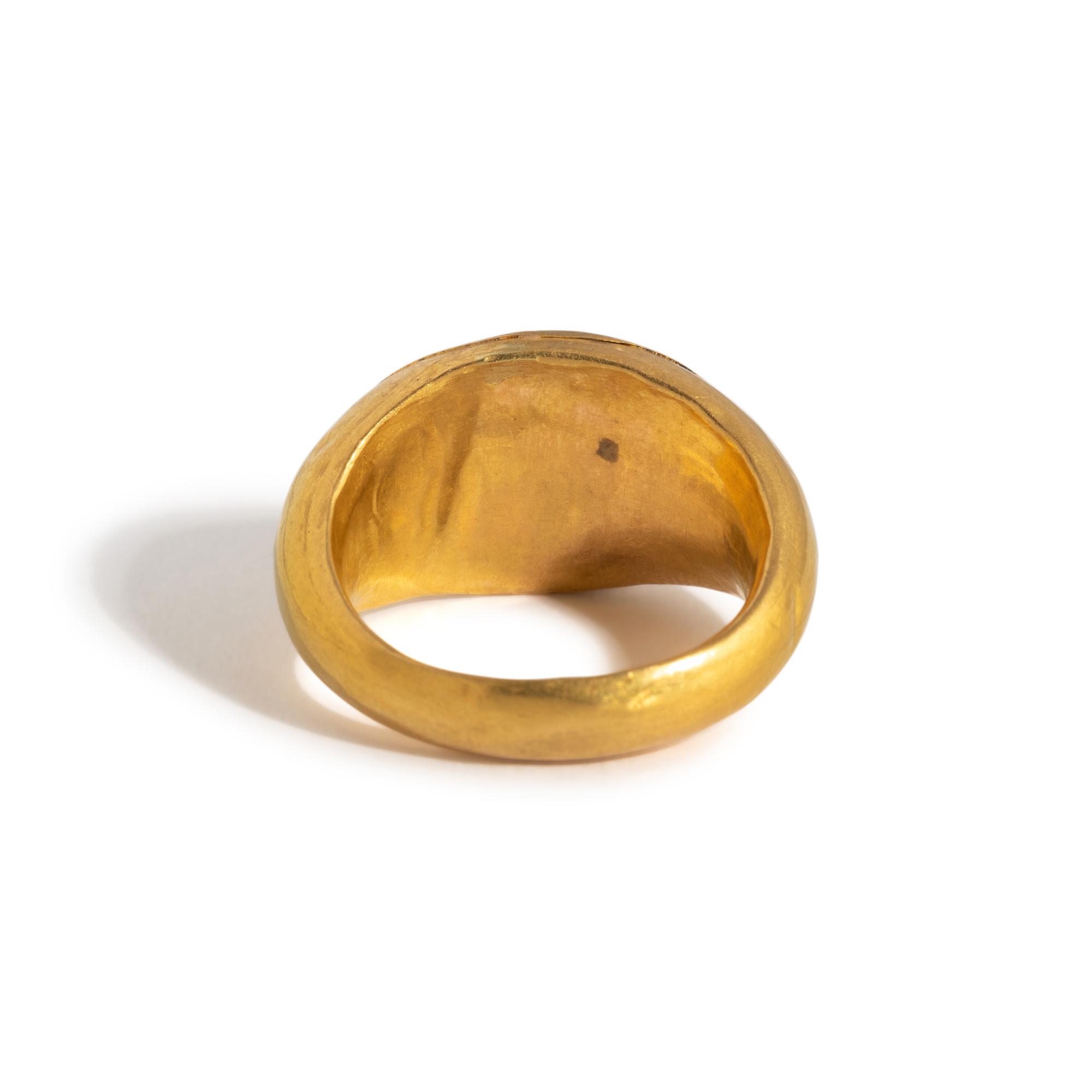 A Roman Gold and Banded Glass Finger Ring with a Kneeling Hero