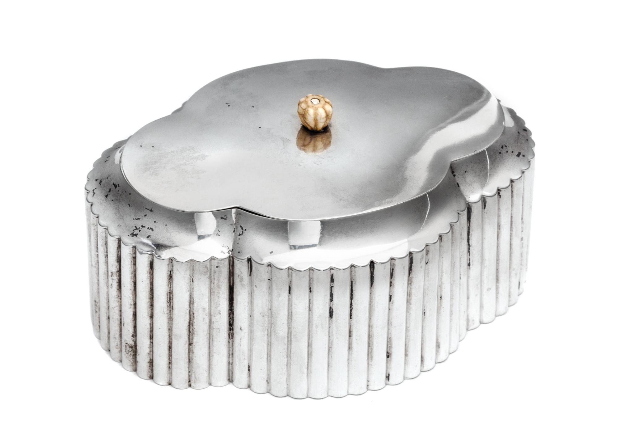 A German Silver Tea Caddy, Wilhelm Weinranck, Hanau, Early 20th Century, having a quatrefoil body with fluted sides.