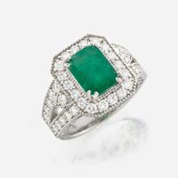An emerald, diamond, and white gold ring