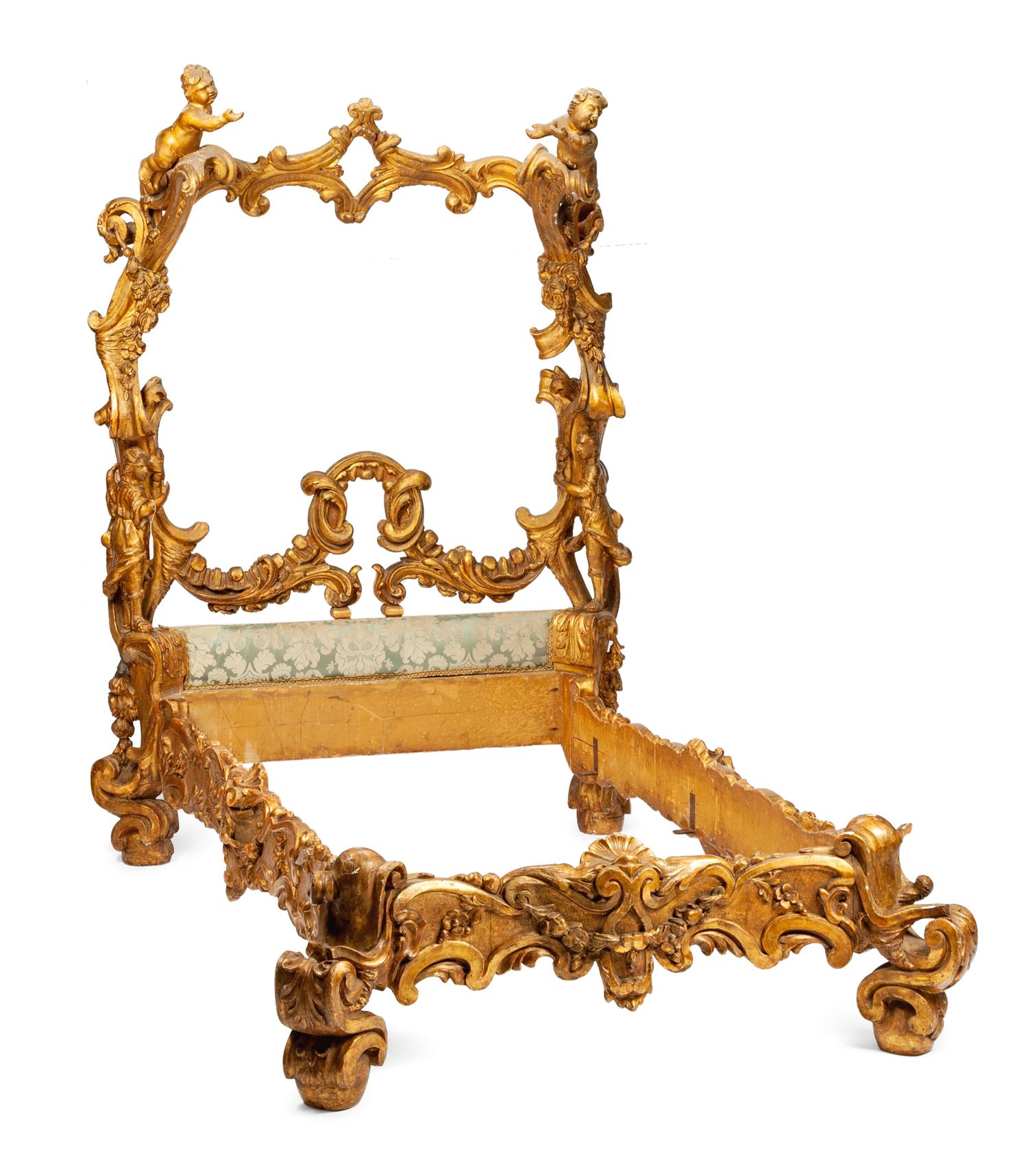 A Venetian Carved and Parcel Gilt Bed Frame