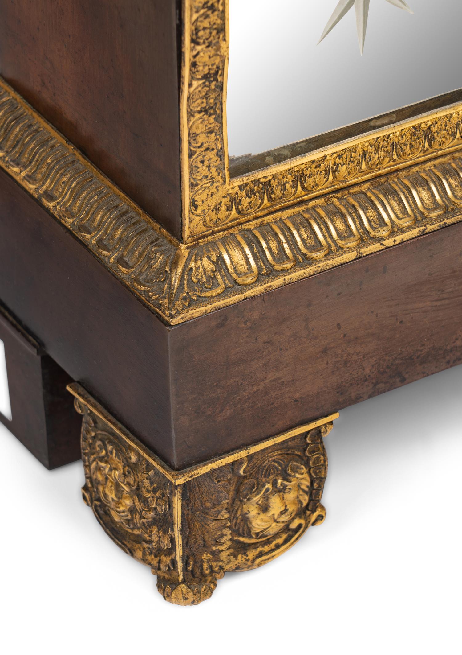 A Charles X Gilt and Patinated Bronze and Mirrored Glass Mantel Clock