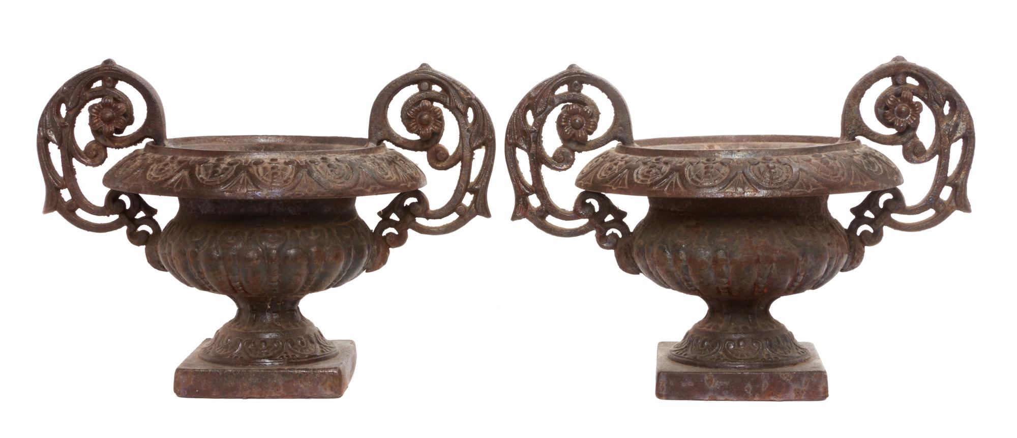 A Pair of Victorian Style Cast Iron Urns Width over handles 17 inches.