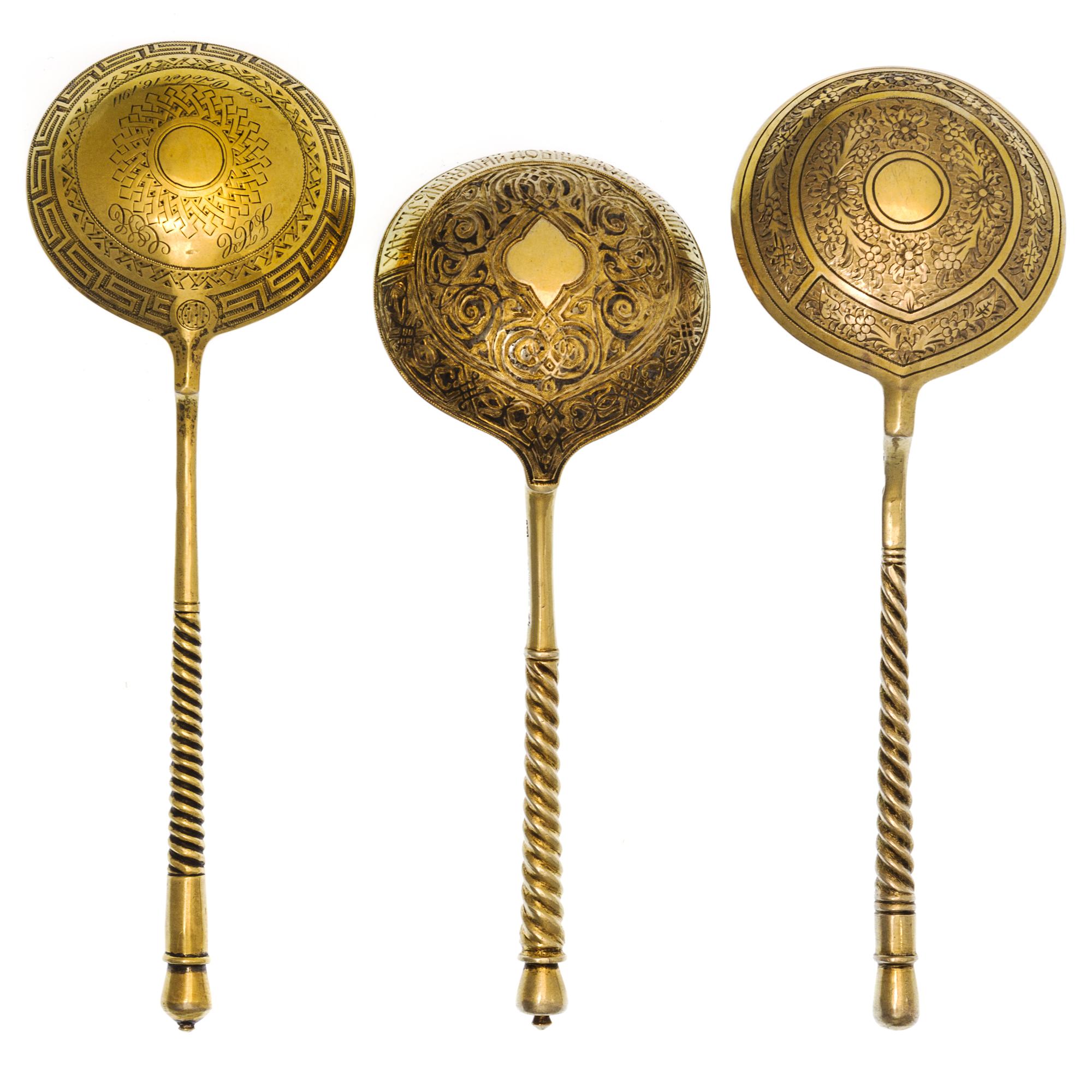 Three Russian Silver-Gilt Serving Spoons, Marks of S. Stroganov, Stepan Levin and GAC, Moscow, 19th century, each having a twist handle