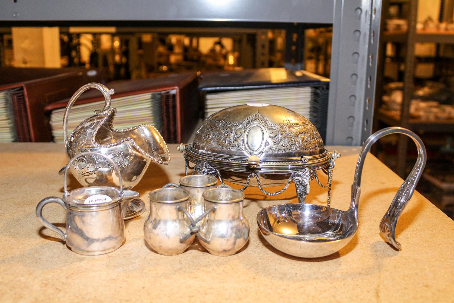 A Group of Seven Silver Plate Table Articles, , comprising a sugar, scoop and fork, butter dish, curved ladle, three-pot condiment dish