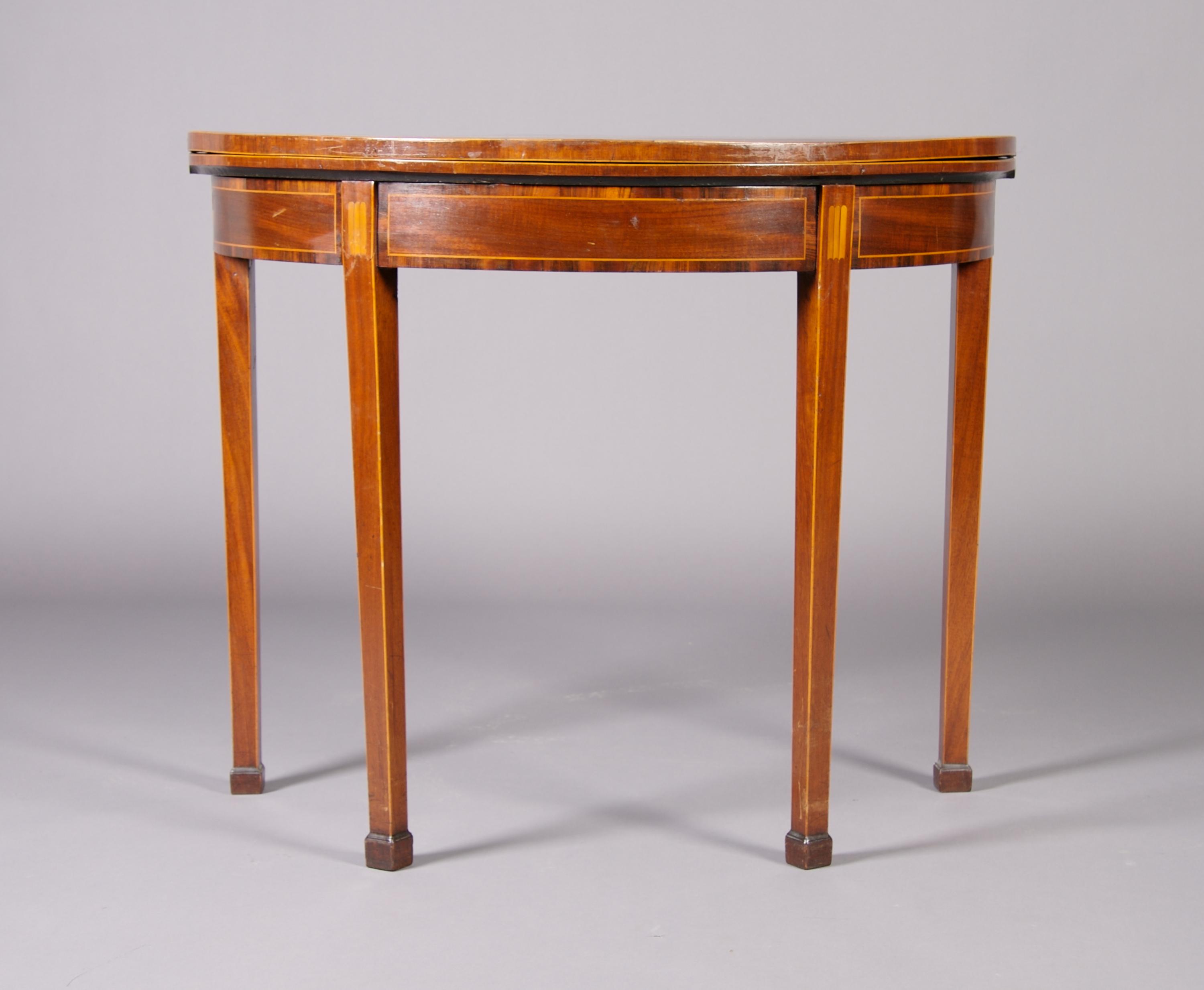 A George III Mahogany and Inlaid Games Table, Height 29 1/8 x width 36 x depth 17 3/4 inches closed.
