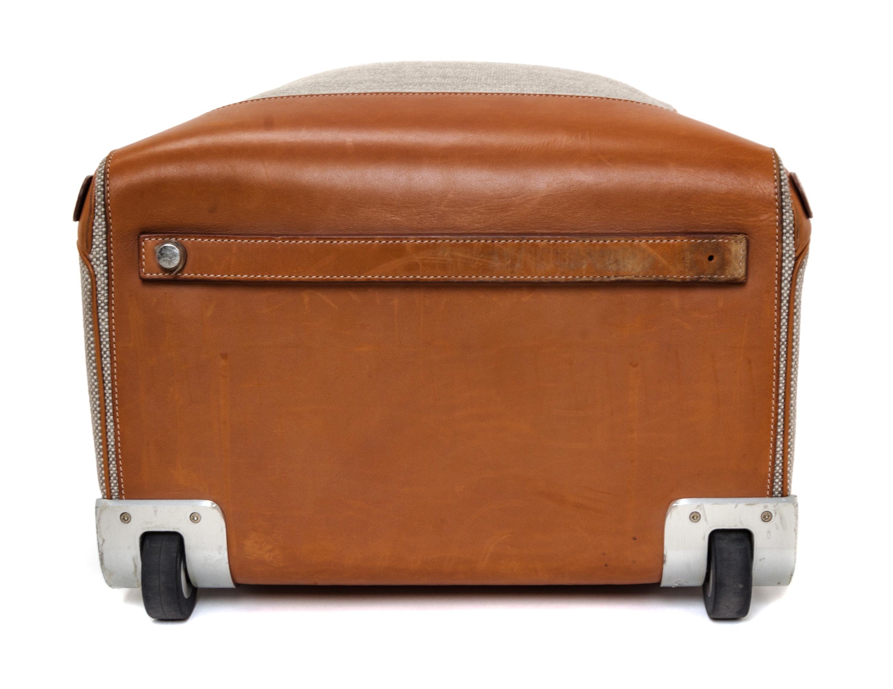 An Hermes Ecru Canvas and Fawn Barenia Calfskin Caleche-Express Suitcase, 14" x 21.5" x 10".