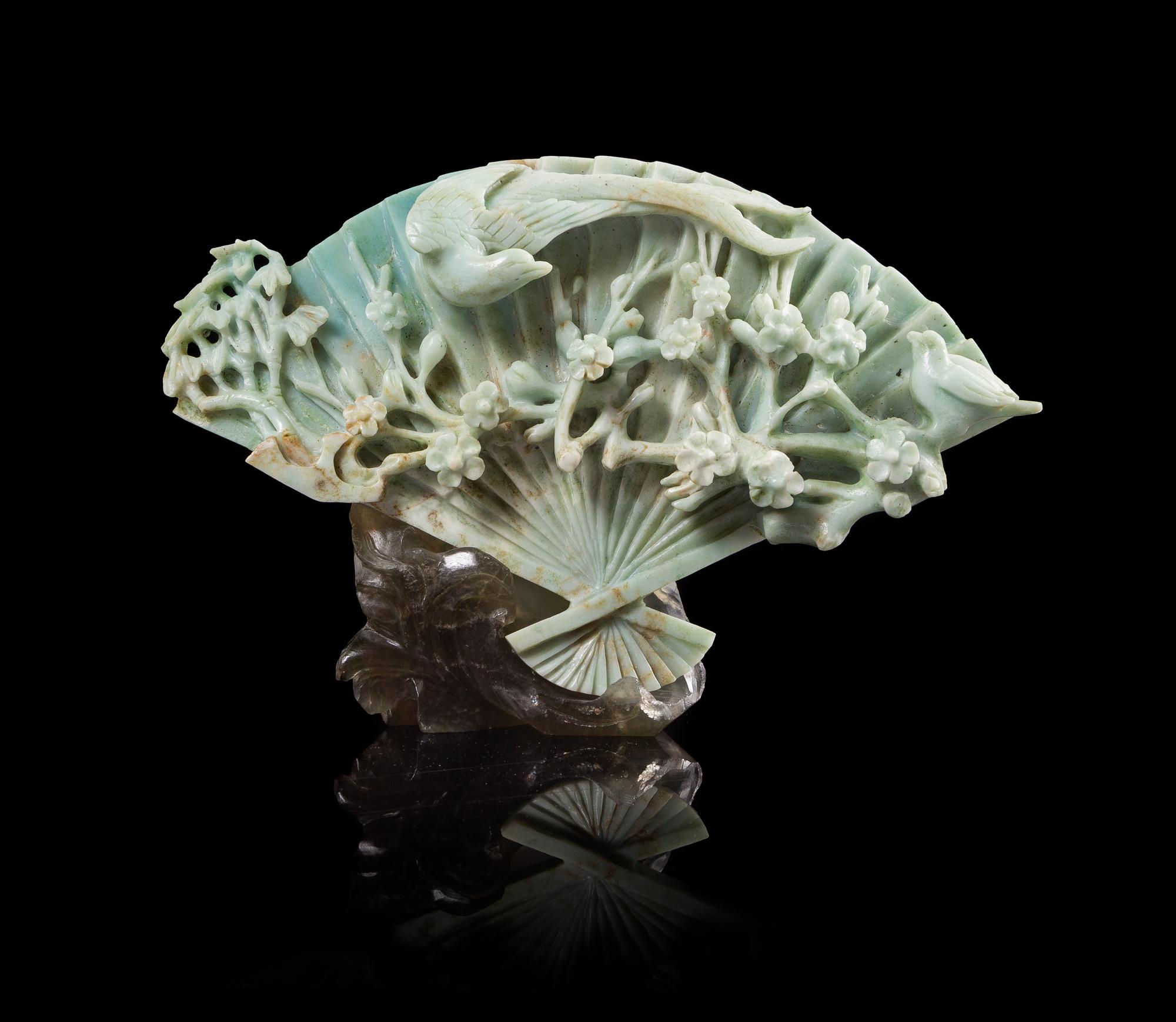 A Chinese Apple Green and Celadon Jadeite Fan-Form Carving