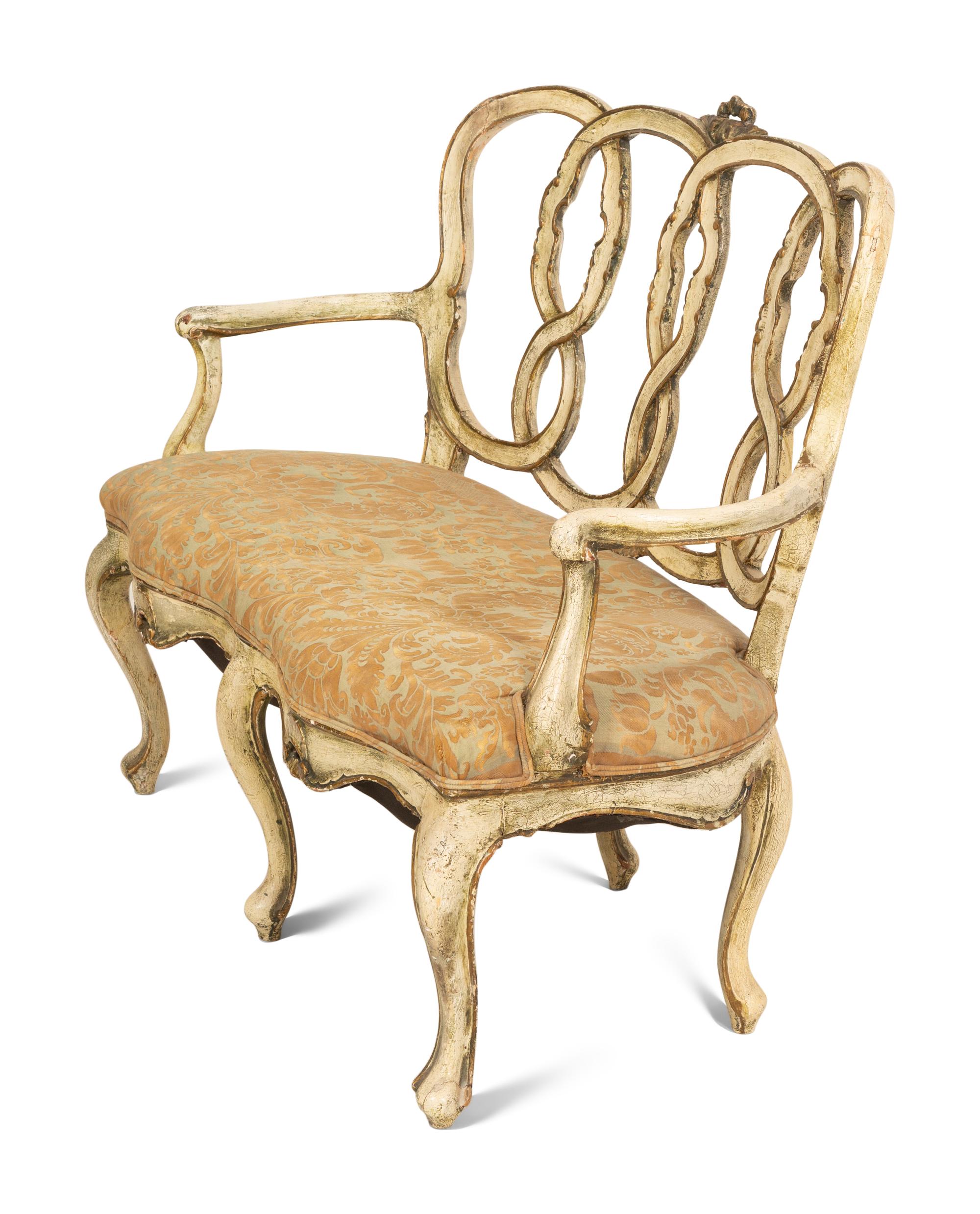 An Italian Painted and Parcel Gilt Settee with Fortuny Upholstery