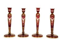 A Set of Four Bohemian Ruby Cut-to-Clear Glass Candlesticks with Gilt Decoration. — 19th Century