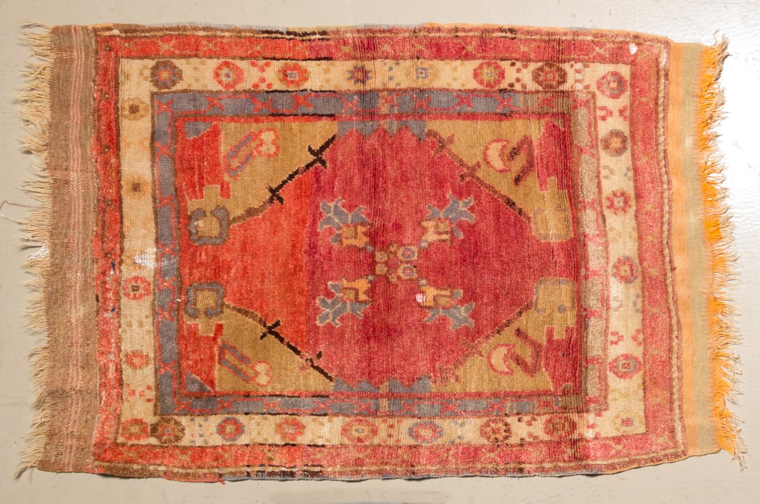 A Persian Wool Mat 2 feet 10 inches x 2 feet 8 inches.
