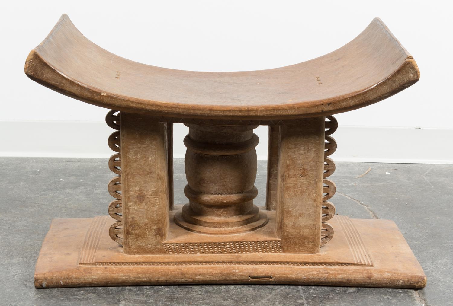 An Ethnographic Carved Wood Bench. Height 18 x width 29 x depth 17 inches.