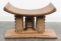 An Ethnographic Carved Wood Bench. Height 18 x width 29 x depth 17 inches.