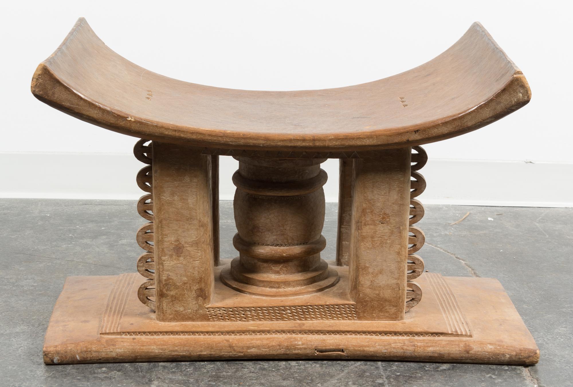 An Ethnographic Carved Wood Bench. Height 18 x width 29 x depth 17 inches.