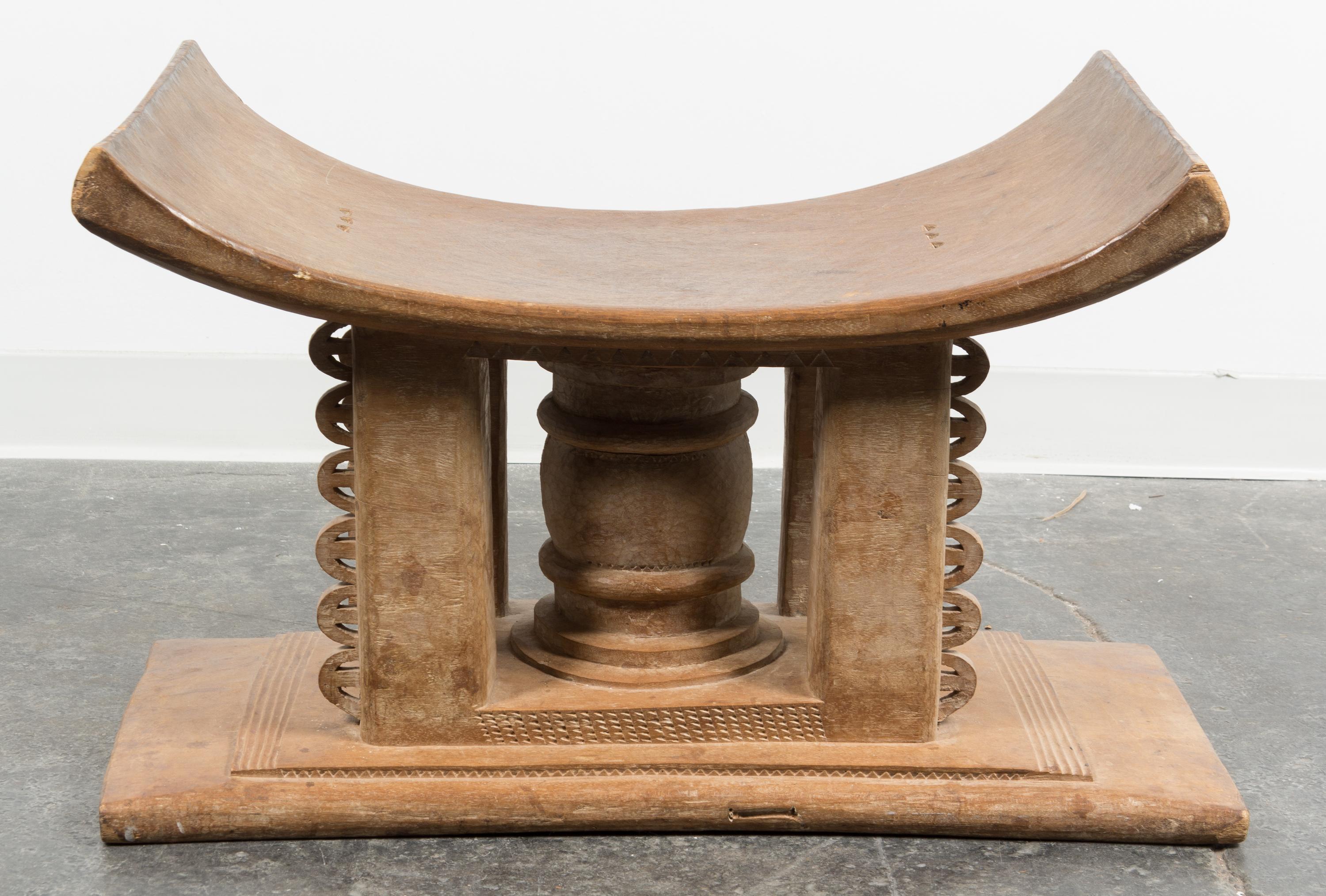 An Ethnographic Carved Wood Bench. Height 18 x width 29 x depth 17 inches.