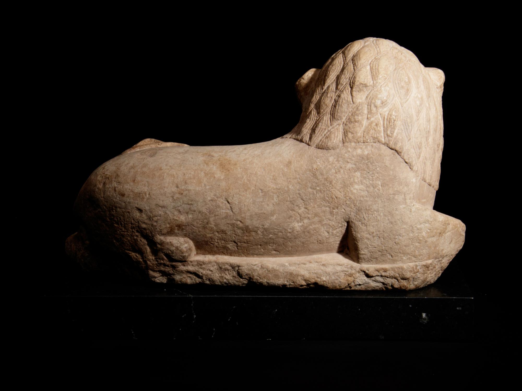 An Egyptian Limestone Recumbent Lion