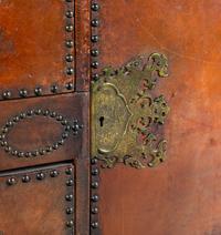 A Spanish Baroque Style Leather-Veneered Side Cabinet