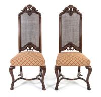 A Pair of Renaissance Revival Walnut Hall Chairs Height 46 1/2 inches. — 20TH CENTURY
