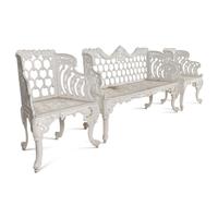 A White-Painted Cast Iron Three-Piece Garden Seating Suite