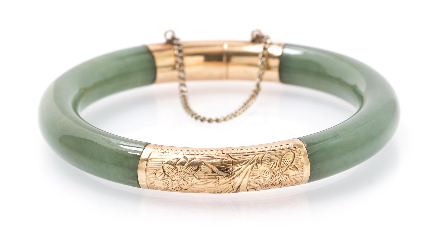 A Jade Open Bangle with Yellow Gold Caps, 23.00 dwts.