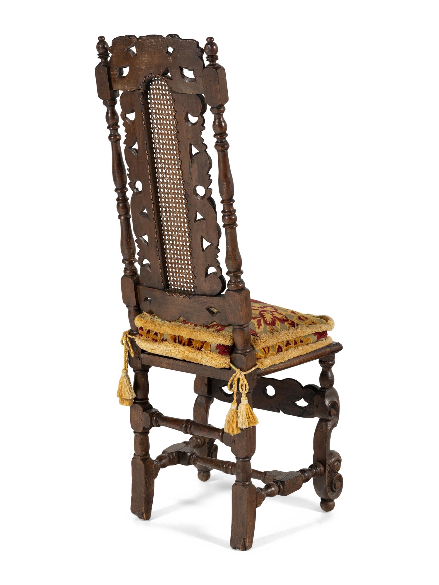 A Set of Four William and Mary Style Carved Oak Dining Chairs