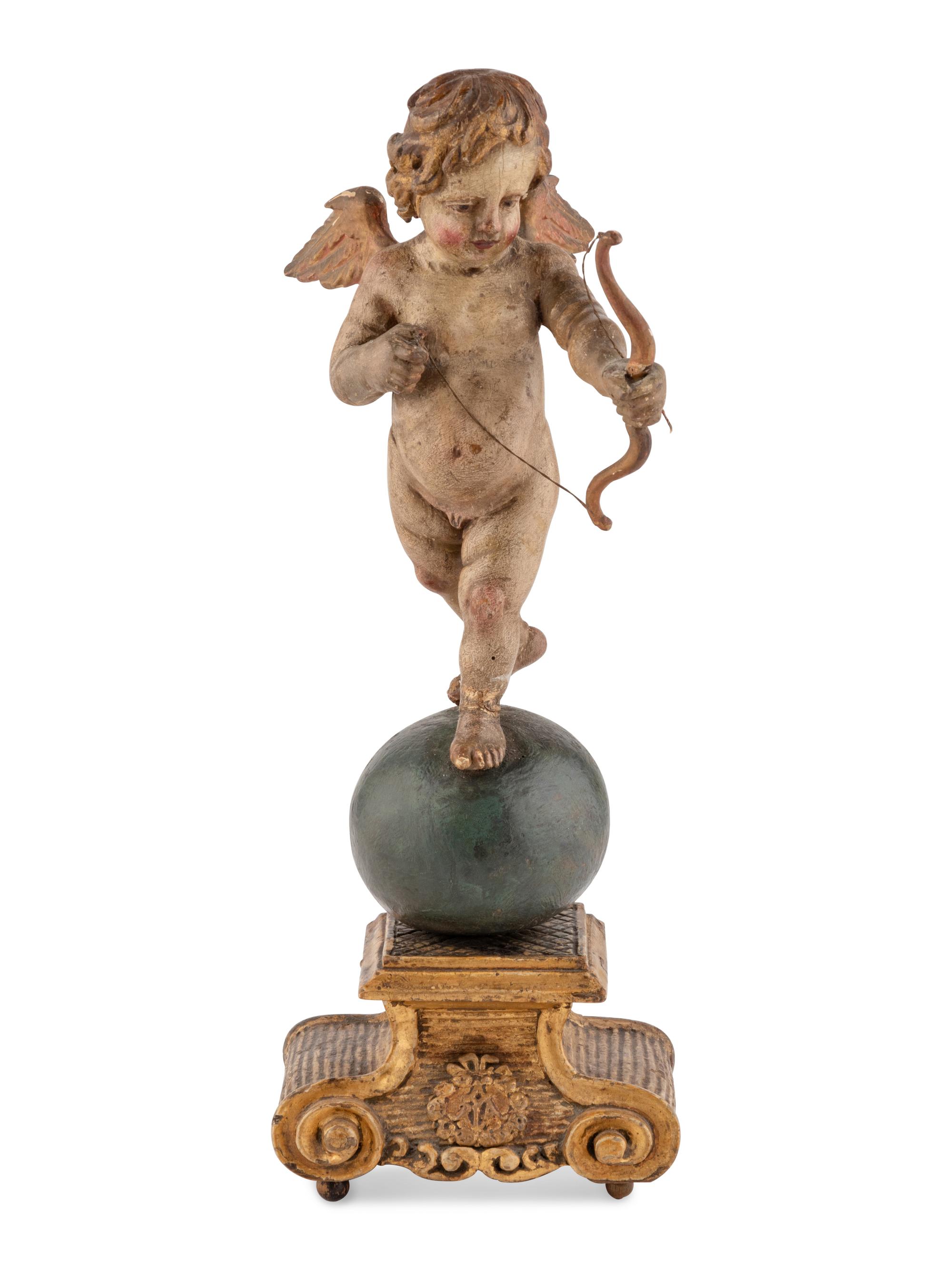 A Continental Painted and Parcel Gilt Cherub Ornament
