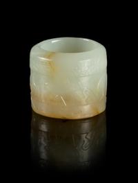 A Celadon and Russet Jade Archer's Ring Height 1 inch.