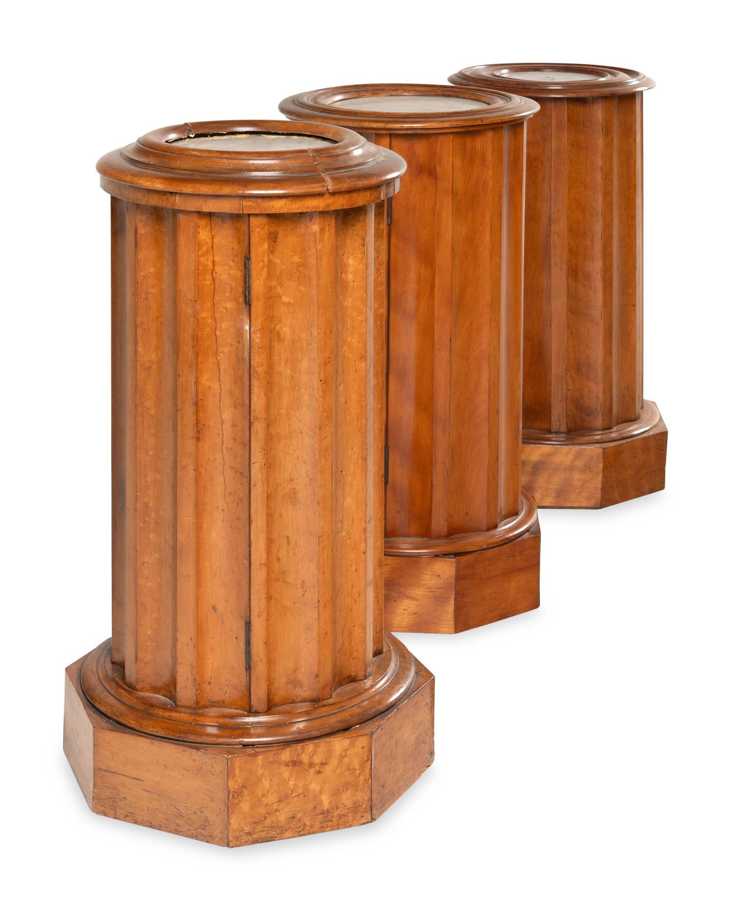 A Set of Three Continental Satin Birch Marble-Top Pedestal Cabinets