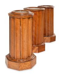 A Set of Three Continental Satin Birch Marble-Top Pedestal Cabinets