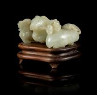 A Carved Celadon Jade Figure of Three Rams Length 2 3/4 inches.